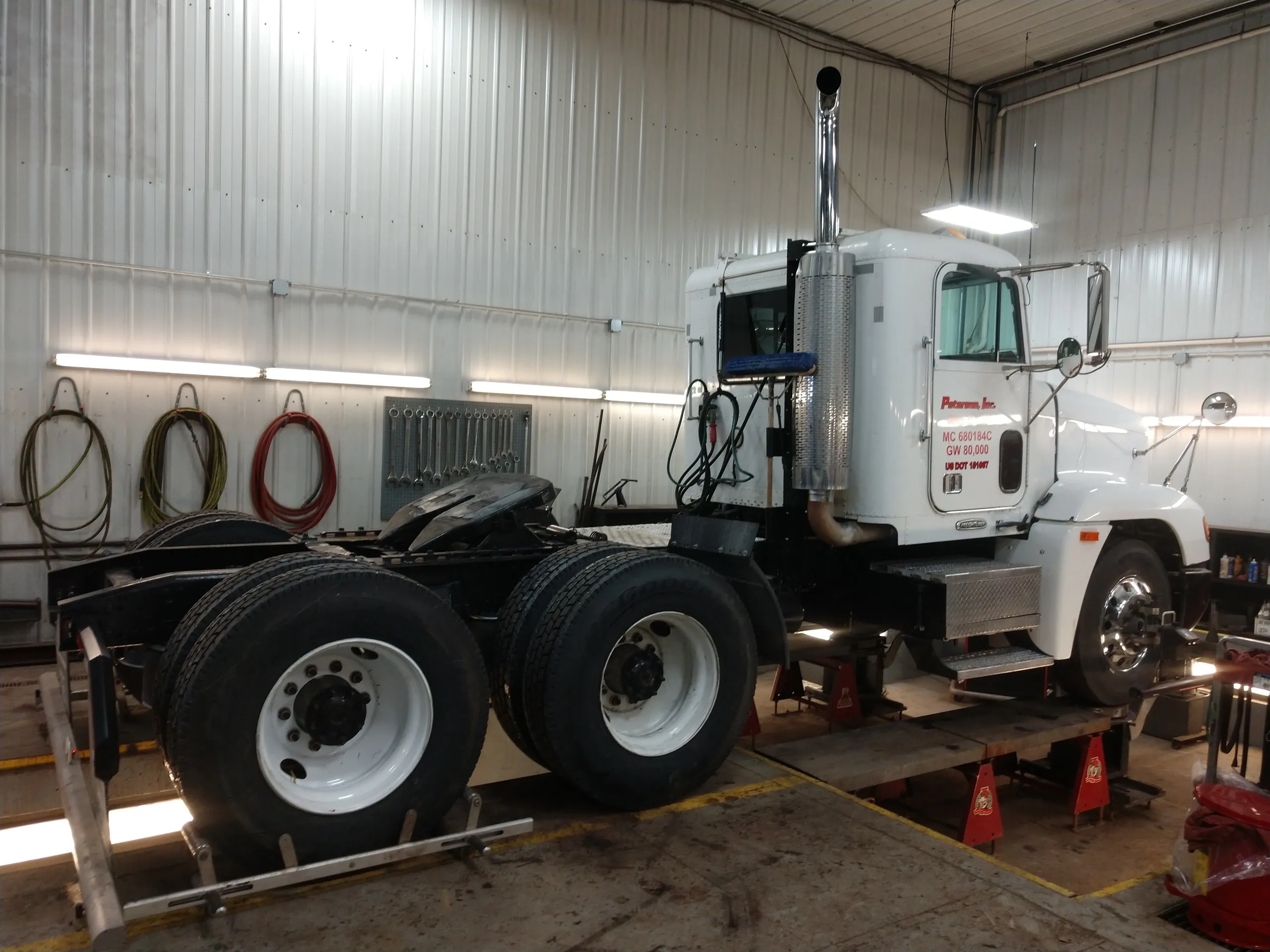 white semi getting a camber correction with alignment service