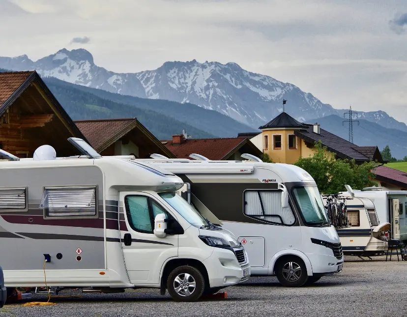 image of RVs and Campers parked in front of a mountain side